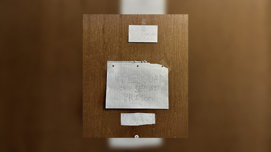 A sign on a dorm room reads upper quad, maximum security prison. In the spring semester of 2021, many students are contemplating if returning to campus is worth it after so many COVID-19 changes to on-campus life. (Cardinal Courier Photo by Madison Weber)