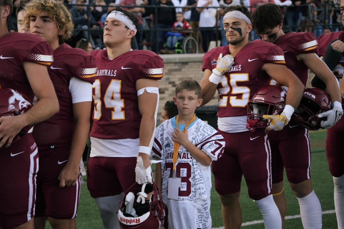 A Camp Good Days camper takes part in the National Anthem (Photo taken by Nicole Pomerleau @frames_by_nicole)