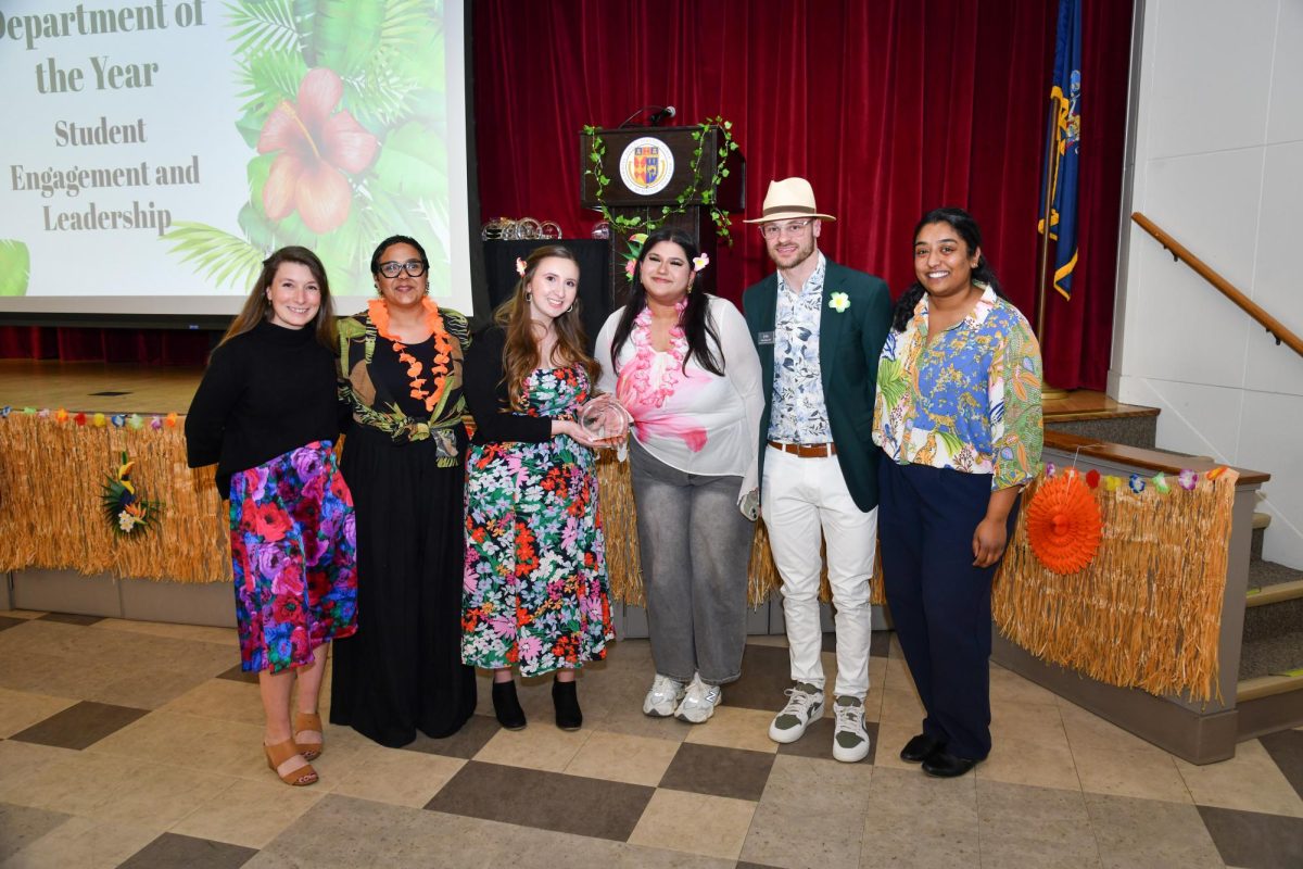 (Left to right) Dr. Meg Flaherty, Bianca Genao, Jasmine Monroe, Tehreem Shah, Chris Keyes and Tiffany Nicholas, members of the Office of Student Engagement and Leadership, pose after receiving the Department of the Year award at the Cardinal Awards on April 8.